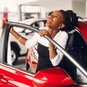 Ebony lady happy after buying a car at a great price