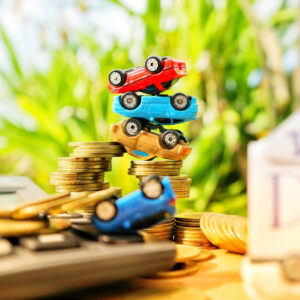 Toy car upside down on coins