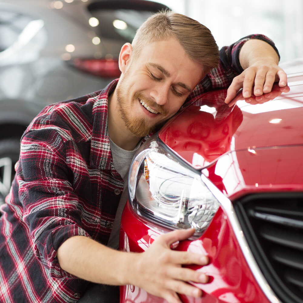 Man with new car after auto loan