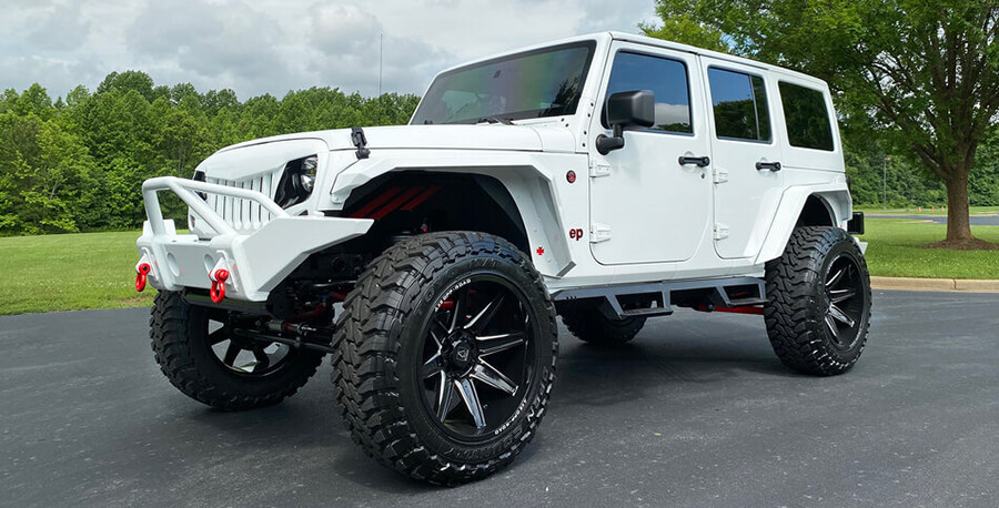 white Jeep Wrangler Custom on road