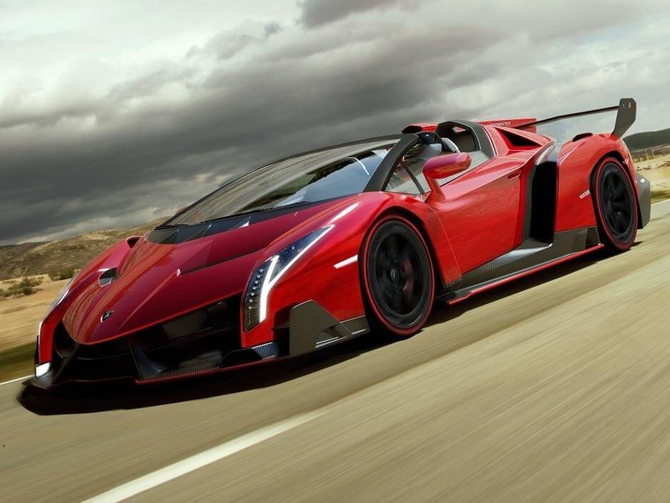 Red Lamborghini Veneno driving down the road
