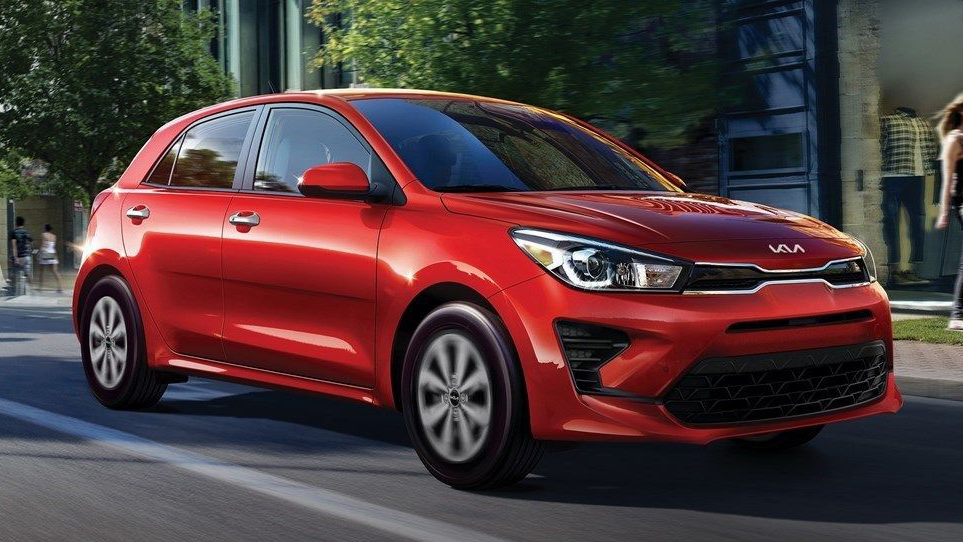 Red 2023 Kia Rio Driving Down Road