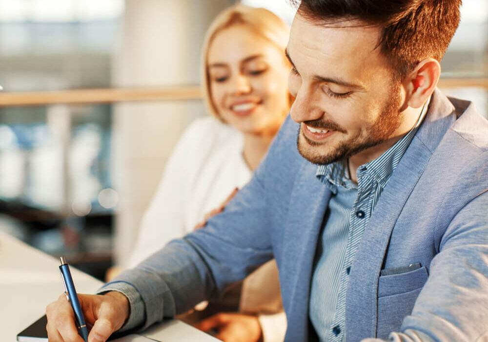 Couple signing papers for new auto loan