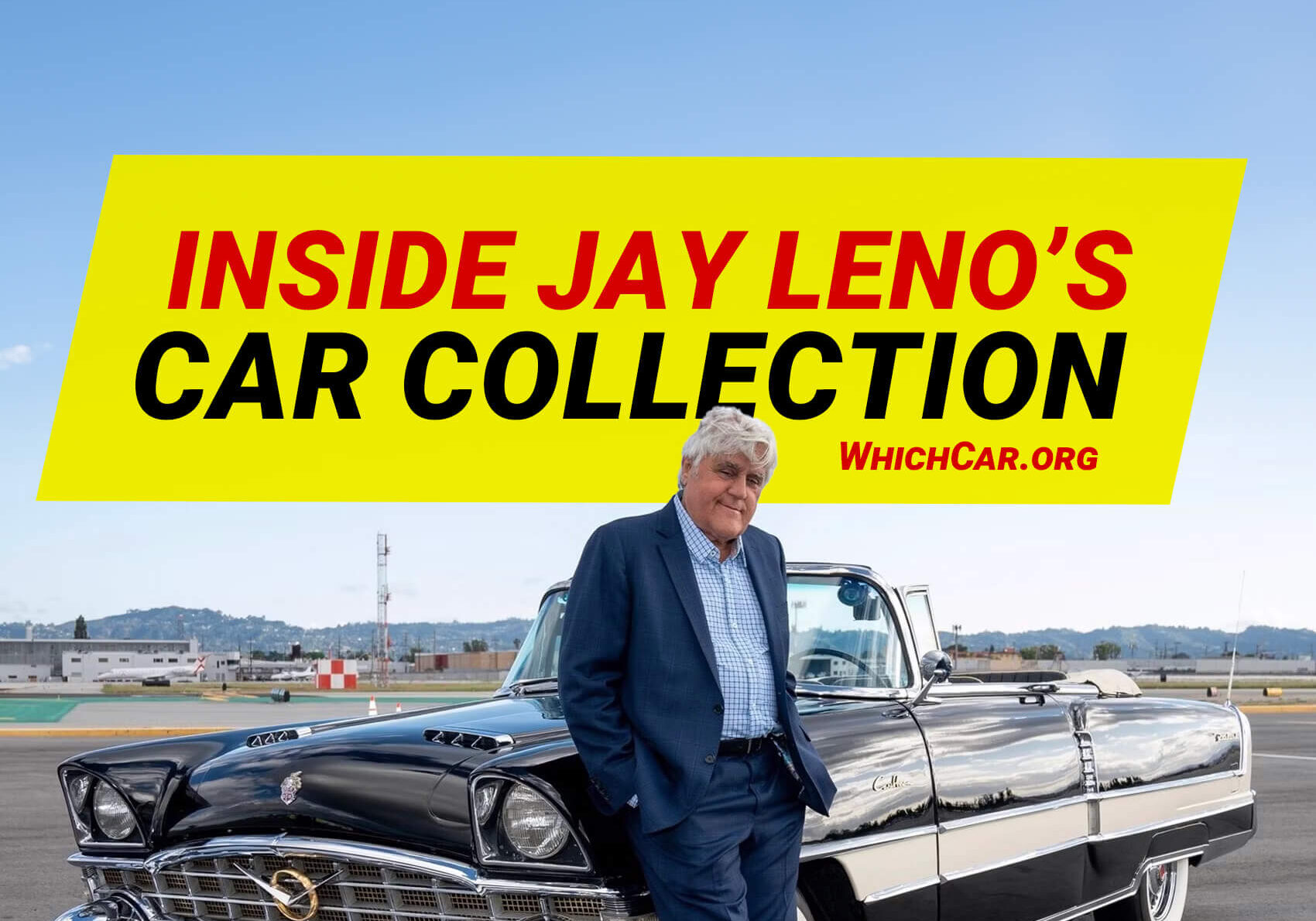 Jay leno posing in front of car collection