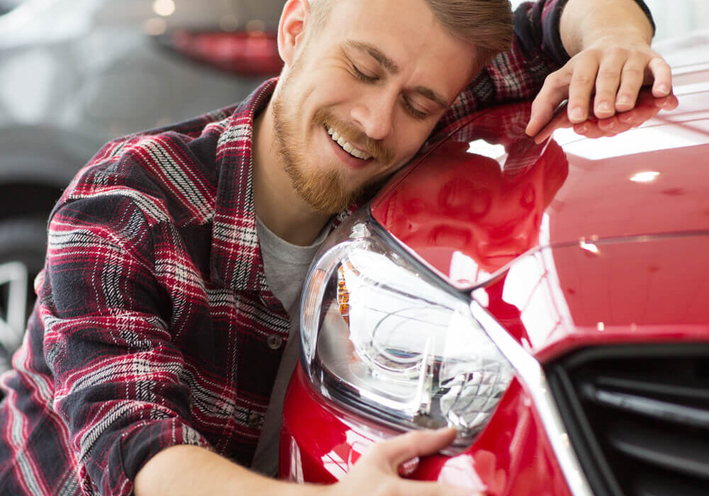 Man with new car after auto loan